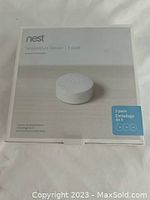 Front view of the sealed box showing the Nest brand, product name, and an image of one white circular temperature sensor along with indication of 3-pack.