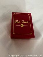 Closed red jewelry box with Alfred Durante branding on top in gold script.