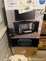 Photo of the Mainstays TV stand box showing brand and suitability for TVs up to 32 inches.