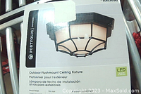 Boxed Portfolio Outdoor Flushmount Ceiling Fixture label showing black finish and LED compatible icon.