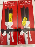 Two boxed Revlon Wave Master Jumbo Waver hair styling tools side by side, in red packaging with black ribbon detail.
