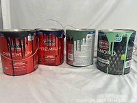 Four 1-gallon paint cans arranged side by side, showing the brand and colors.