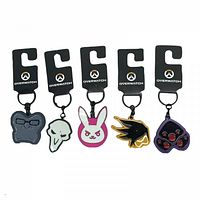 Five Overwatch metal keychains displayed on black branded Overwatch tags showing different character face icons and logos in detail.