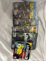 Six PC games displayed: four copies of RollerCoaster Tycoon World, one Call of Duty Infinite Warfare, one Legends Wanderer/Suspicion combo game.