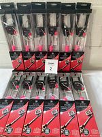 Photo showing 12 packaged Smart extendable selfie wands arranged in two rows of six each.
