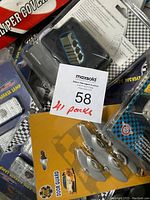 Photo showing assortment of car accessory packs including caliper covers, side marker lamps, and door guards in packaging.