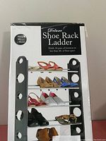 Front view of shoe rack ladder box showing product holding multiple pairs of shoes and capacity details.