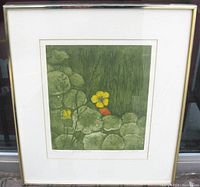 Front view of framed print showing botanical image with yellow and orange flowers among green leaves.