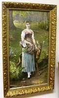 Full front view of the lithographic print in its gilt ornate frame showing the woman, deer and forest background.