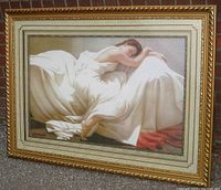 Framed art print showing a peaceful sleeping maiden draped in white on a bed, ornate gold decorative wood frame.