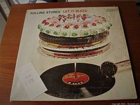 Front cover of the Rolling Stones Let It Bleed vinyl LP with original Sherman's 1975 purchase receipt attached.