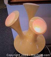 Vintage BOON 3 pod lamp lit with different colors, showing red, yellow, green lighting effects on trumpet-shaped pods attached to plastic base