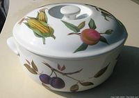 Full view of vintage Royal Worcester Evesham round casserole dish with lid, showing hand-painted corn and peach motif