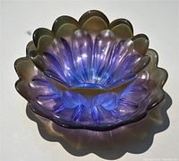 Top angled front view of the purple alexandrite glass bowl showing scalloped design and color shift with ambient light