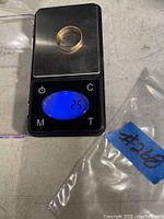 10KT gold ring placed on a digital scale showing weight 2.5 grams.
