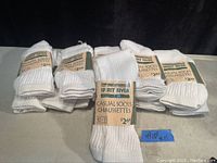 Photo showing 11 pairs of Spirit River white casual socks, size 10-13, all new, with original packaging and tags.