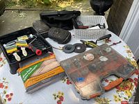 Overview of lot including tool storage box with hardware, kneepads, grinding discs, white basket with various tools.