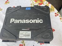 Closed black Panasonic Tough IP carrying case with model EY7541LZ2S and 3.1Ah Li-Ion battery label.