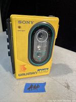 Front view of the yellow Sony Sports Walkman showing the analog radio frequency dial and branding.
