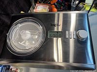 Top view showing the digital display timer 60:00, three control buttons, Total Chef branding, and clear lid over mixing blade.