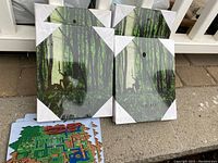 Four framed, shrink-wrapped framed canvas prints showing a forest silhouette scene of Link from Legend of Zelda, each about 12 inches tall.