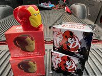 Two boxed Ironman molded ceramic mugs shown in red with yellow faceplates. Each box states 6 oz ceramic molded mug with Marvel branding.