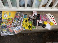 Overview photo showing assorted video game posters, toys, stickers, and accessories including Mario Kart characters, controllers, and novelty items.