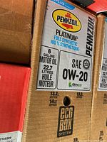 Front of sealed Pennzoil Platinum Eco Box showing 6 gallons (22.7 L) motor oil, SAE 0W-20 viscosity and Dexos1 approval.