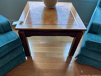 Front view of the solid wood end table showing the top surface and legs.