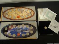 Full view of 1999 and 2000 Millennium Coin Collections laid out in original trays with Canada Post dove token and paperwork displayed to the right.