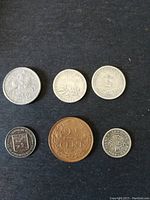 Six coins including Spain aluminum 5 cents 1941, France 50 centimes 1916, Hong Kong 5 cents 1904, and others.