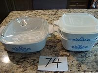 All three Corning Ware casserole dishes shown with their lids, displaying the blue cornflower pattern.