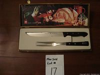Carving knife and fork in original wood box, with food imagery on lid and Max Sold lot number.