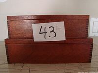 Two wooden keepsake boxes stacked, showing dovetail corners and rectangular shape with hinged lids.