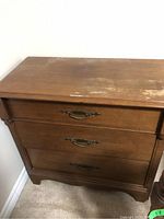 Front view of Gibbard dresser showing three drawers with antique style metal handles, solid wood finish.