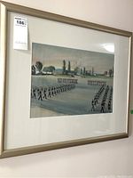 Framed artwork showing a parade scene with soldiers marching in formation.