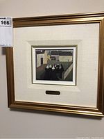 Framed art print showing nuns gathered outdoors with buildings behind them.