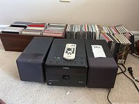 Front view of Yamaha system with remote on top and DVDs behind