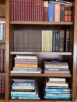 Bookshelves with a variety of books focusing on music and art, showing the full assortment