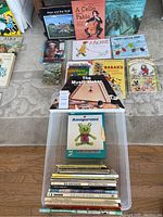 Overview of various children's books laid out on carpet and the Music Maker kit boxed in front.