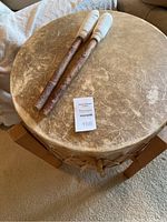 Overhead view of drum head showing leather surface and two mallets