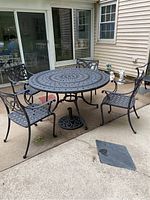 Broad view of round table with four chairs on concrete patio