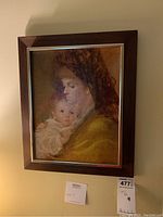 Framed wall art painting of a woman holding a baby with dark wooden frame and silver inner border, signed H. Centi Pirini in bottom right corner.