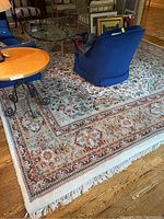 Overall view of rug under furniture showing full size and pattern