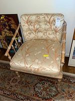 Front view of the bamboo style chair featuring floral cushioned seat and backrest.