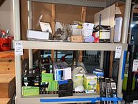 Shelves with multiple boxes of various light bulbs and bulbs in original packaging