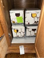 Six boxes of Luigi Bormioli Canaletto crystal stemware, each holding four glasses.