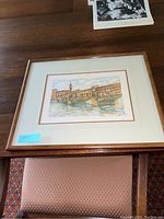 Smaller framed wall art print showing a historic cityscape with water and bridge, signed and numbered, size 10x12 inches.