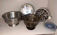 Photo of the five items: blue Wedgwood plate, tin bowl, decorative enamel floral bowl, floral bowl, and Wedgwood-style decorative plate