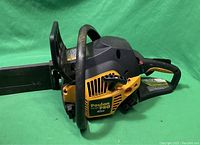 Poulan Pro 42CC gas chainsaw showing side view with yellow and black housing and wrapped handle.